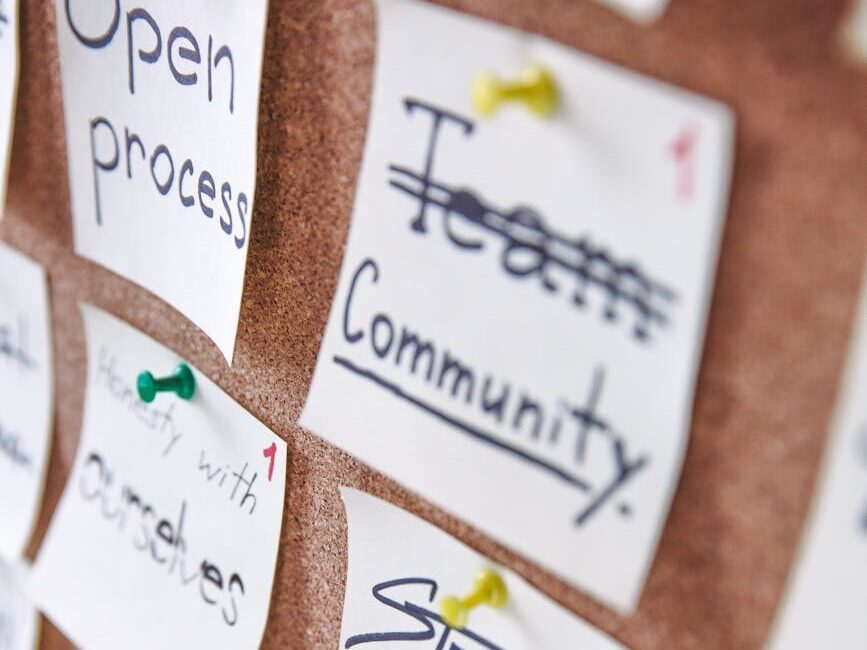 Pinned notes on a corkboard showcasing team collaboration and design skills.